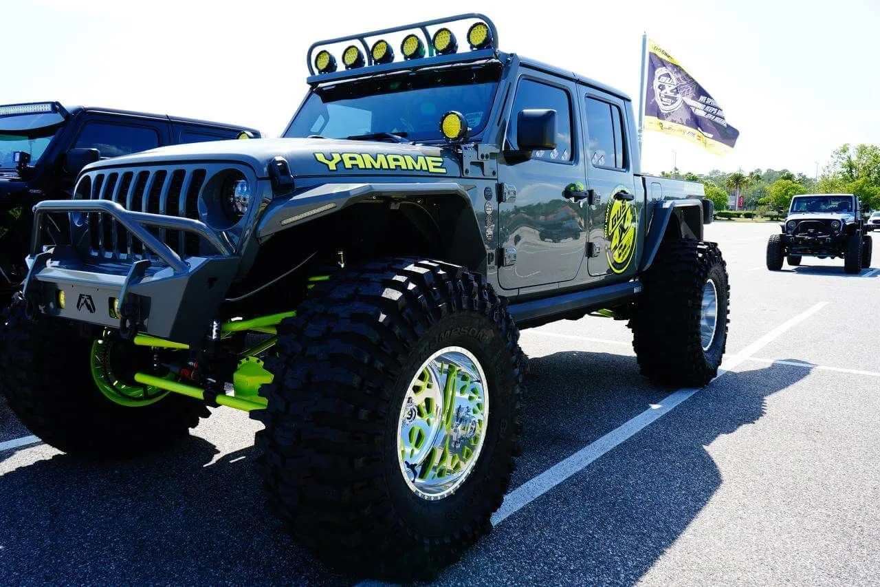 Gray Gladiator with green accents and lift kit