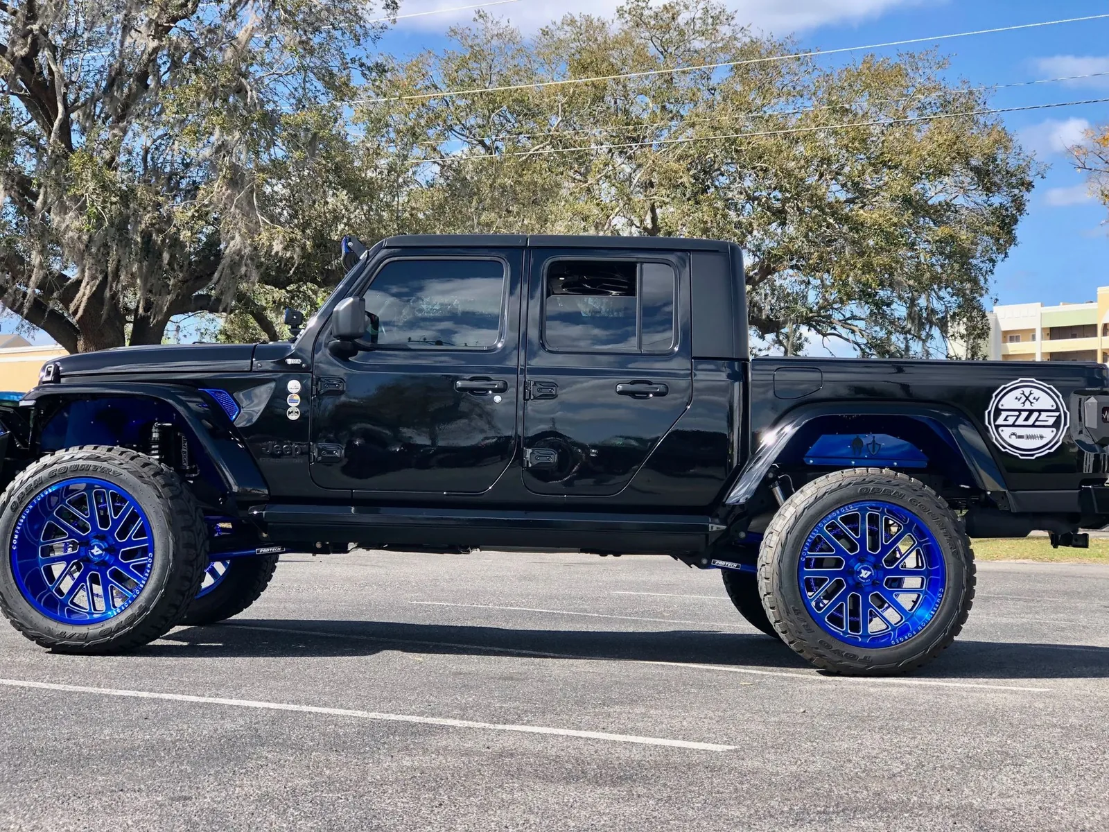 Black Gladiator with blue custom wheels